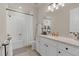 Bright bathroom with a granite countertop, white cabinetry, and tub with shower at 13640 Haulover Beach Ln, Orlando, FL 32827