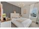 Stylish bedroom with a unique accent wall, plush bed, and natural light at 13640 Haulover Beach Ln, Orlando, FL 32827