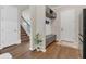 Welcoming entryway with coat rack, bench, and wood-look flooring, leading to a staircase at 13640 Haulover Beach Ln, Orlando, FL 32827