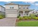 Charming two-story home featuring a stone facade, front porch, and well-maintained landscaping at 13640 Haulover Beach Ln, Orlando, FL 32827