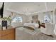 Light-filled main bedroom with chandelier, tray ceiling, and large windows at 13640 Haulover Beach Ln, Orlando, FL 32827