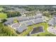 Aerial view of new townhome development with a community pool, pond, and beautifully landscaped grounds at 1438 Brookdale Ct, Oviedo, FL 32765