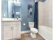 Bathroom featuring blue walls, shower with curtain, toilet, and white vanity with modern sink at 1438 Brookdale Ct, Oviedo, FL 32765
