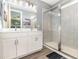 Contemporary bathroom featuring double sinks, white cabinets, a glass enclosed shower and modern fixtures at 1438 Brookdale Ct, Oviedo, FL 32765