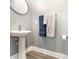 Charming powder room with pedestal sink, oval mirror, and modern fixtures at 1438 Brookdale Ct, Oviedo, FL 32765