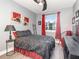 Bedroom with ceiling fan, grey walls, window with red curtains, artwork, and stylish dark furniture at 1438 Brookdale Ct, Oviedo, FL 32765