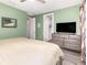 Inviting bedroom with a bed, dresser, and neutral color scheme at 1438 Brookdale Ct, Oviedo, FL 32765