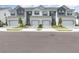 The exterior displays several townhomes with two car garages, green lawns, and paver driveways at 1438 Brookdale Ct, Oviedo, FL 32765