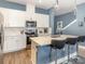 Bright, updated kitchen with stainless steel appliances, sleek white cabinets, and a large island with barstools at 1438 Brookdale Ct, Oviedo, FL 32765