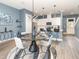 This great room has a dining area next to a kitchen with pendant lights and stainless appliances at 1438 Brookdale Ct, Oviedo, FL 32765