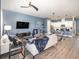 A large living room is open to the kitchen and features hardwood floors and modern paint at 1438 Brookdale Ct, Oviedo, FL 32765