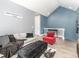 Living room with vaulted ceiling, light gray walls, and contemporary furniture arrangement and modern decor at 1438 Brookdale Ct, Oviedo, FL 32765