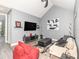 Living room featuring vaulted ceiling, modern furniture, and TV with streamlined decor at 1438 Brookdale Ct, Oviedo, FL 32765