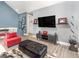 Living room featuring TV on wall, modern furniture, gray walls, and modern decor at 1438 Brookdale Ct, Oviedo, FL 32765