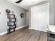 Office featuring gray walls, white closet doors, and modern black shelf with decorative items at 1438 Brookdale Ct, Oviedo, FL 32765