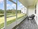 Screened patio offers lovely backyard pond view with wicker seating, ideal for relaxing outdoors at 1438 Brookdale Ct, Oviedo, FL 32765