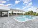 Community pool and cabana surrounded by a paved patio and lush landscaping, ideal for relaxation at 1438 Brookdale Ct, Oviedo, FL 32765