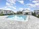 Community pool area with lounge chairs and a cabana, perfect for enjoying sunny days and relaxation at 1438 Brookdale Ct, Oviedo, FL 32765