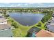 Scenic aerial view of a lakefront property, featuring a screened pool and expansive backyard at 14819 Braywood Trl, Orlando, FL 32824