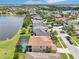 Stunning aerial view of homes along a lake, showcasing a community pool and well-manicured lawns at 14819 Braywood Trl, Orlando, FL 32824