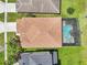 Overhead shot of a home featuring a screened pool enclosure, roof and tidy landscaping at 14819 Braywood Trl, Orlando, FL 32824