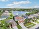 Expansive aerial shot showcasing a home nestled by a serene lake within a vibrant community at 14819 Braywood Trl, Orlando, FL 32824