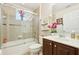 Bathroom with tub and shower combo and a single sink vanity with dark wood cabinetry at 14819 Braywood Trl, Orlando, FL 32824