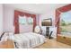 Bedroom featuring hardwood floors, large windows, television, and a comfortable bed at 14819 Braywood Trl, Orlando, FL 32824