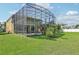 Back of the house exterior view with a large screened-in patio and pool at 14819 Braywood Trl, Orlando, FL 32824