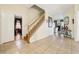 Elegant foyer with tile flooring, staircase, and views into adjacent living spaces at 14819 Braywood Trl, Orlando, FL 32824