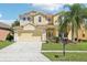 Charming two-story home featuring a well-manicured lawn, a two-car garage, and a beautifully landscaped yard at 14819 Braywood Trl, Orlando, FL 32824