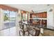 Kitchen with stone accents, cherry cabinets, granite countertops and breakfast bar with views to pool at 14819 Braywood Trl, Orlando, FL 32824