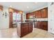 Kitchen with cherry cabinets, granite countertops, tile floors, stainless appliances and breakfast bar at 14819 Braywood Trl, Orlando, FL 32824