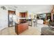 Large kitchen with stainless appliances, island, stone accents, tile floors and open to Gathering room at 14819 Braywood Trl, Orlando, FL 32824