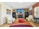 Bright living room featuring a decorative stone wall, large windows, and comfortable seating at 14819 Braywood Trl, Orlando, FL 32824