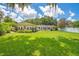 Expansive backyard with lush lawn, mature trees, and a charming patio area for outdoor enjoyment at 1511 Crestline St, Orlando, FL 32806