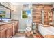 Stylish bathroom with wood-look tile, a modern soaking tub, and an invigorating rainfall shower at 1511 Crestline St, Orlando, FL 32806