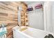 Close up of a soaking tub and rainfall shower in a stylish bathroom featuring wood-look tile at 1511 Crestline St, Orlando, FL 32806