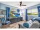 Cozy bedroom with light blue walls, wood look flooring and large windows at 1511 Crestline St, Orlando, FL 32806