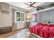 Comfortable bedroom featuring built-in storage, wood look flooring and large window at 1511 Crestline St, Orlando, FL 32806
