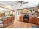 Rustic kitchen featuring exposed brick accents, an island, and modern appliances at 1511 Crestline St, Orlando, FL 32806