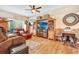 Cozy living room with wood flooring, comfortable seating, and custom built-in shelving and entertainment center at 1511 Crestline St, Orlando, FL 32806