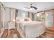 Serene bedroom featuring barn door to bathroom, wood floors, and elegant decor for a relaxing retreat at 1511 Crestline St, Orlando, FL 32806