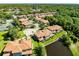 Aerial view showing residential neighborhood with terra cotta roofs and lush landscape at 1561 Corkery Ct, Winter Springs, FL 32708