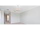 Bedroom with neutral walls, an elegant chandelier, and access to other rooms at 1561 Corkery Ct, Winter Springs, FL 32708