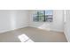Bright bedroom featuring neutral carpet, large window with blinds, and ample natural light at 1561 Corkery Ct, Winter Springs, FL 32708