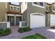 Townhome exterior showcasing a well-manicured entrance, a white garage door, and a cozy walkway at 1561 Corkery Ct, Winter Springs, FL 32708