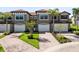 Aerial view of townhome showcasing lush landscaping, inviting brick driveways, and attached garages at 1561 Corkery Ct, Winter Springs, FL 32708