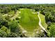 Aerial view of a lush green golf course surrounded by mature trees and sand traps at 1561 Corkery Ct, Winter Springs, FL 32708