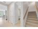 Bright hallway with tile floors, staircase, and doorway leading to bathroom at 1561 Corkery Ct, Winter Springs, FL 32708